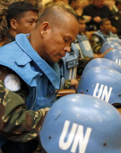 Some of the 21 Filipino United Nations peacekeepers arrive at Jordanian army headquarters in Amman, Jordan, on Saturday. (Associated Press)