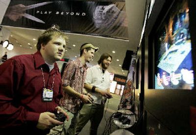 
Russ Christensen a Microsoft XBOX 360 programmer, plays a video game on a Sony Playstation on display at the Electronic Entertainment Expo (E3) Tuesday. 
 (Associated Press / The Spokesman-Review)