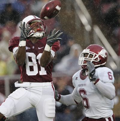 Battling the rain, Stanford wide receiver Chris Owusu hauls in a pass in front of Washington State cornerback Markus Dawes.  (Associated Press / The Spokesman-Review)