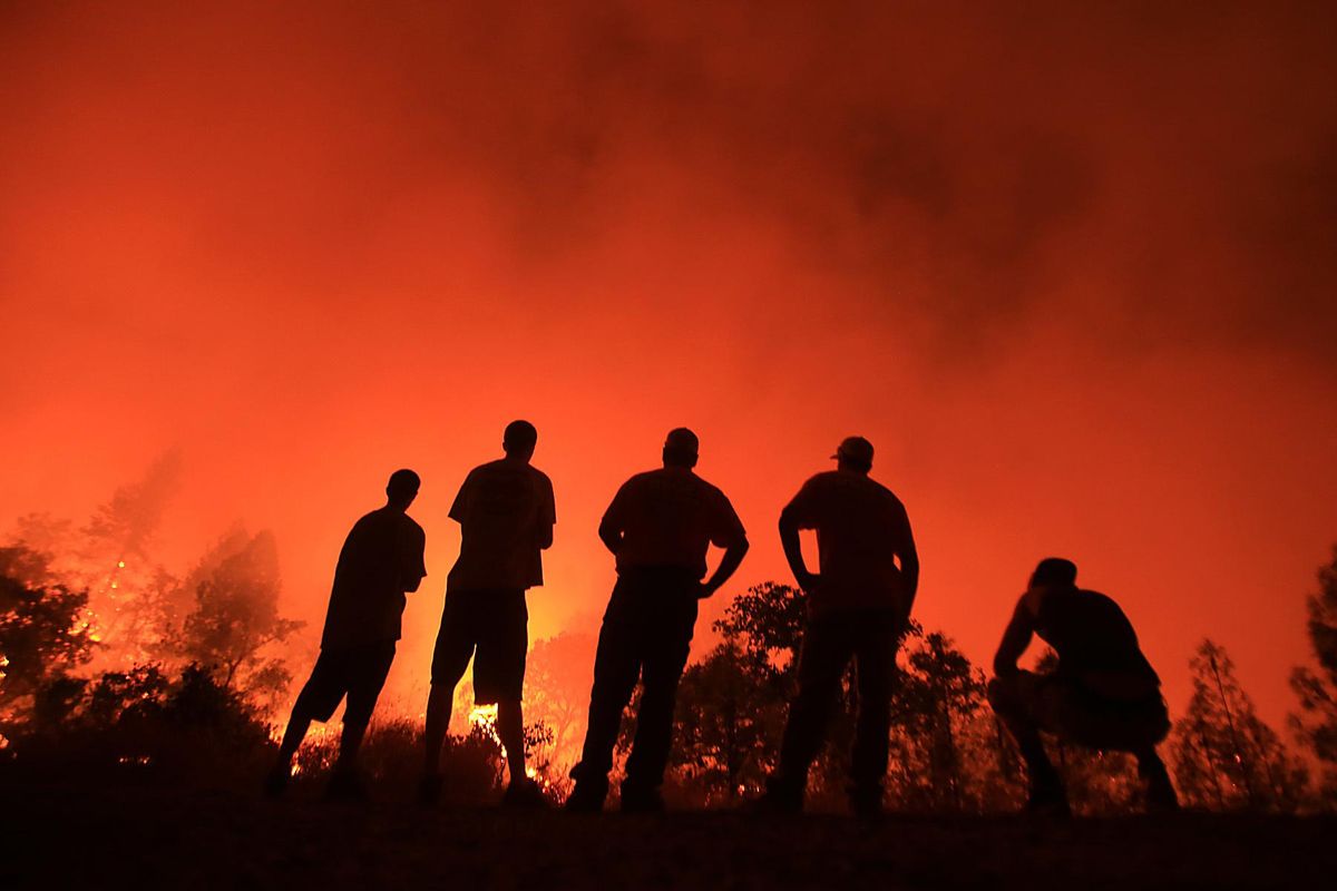 Residents watch as a wildfire burns near their homes off Morgan Valley Road in Lower Lake, Calif., Saturday Aug. 13, 2016. (Kent Porter / Associated Press)