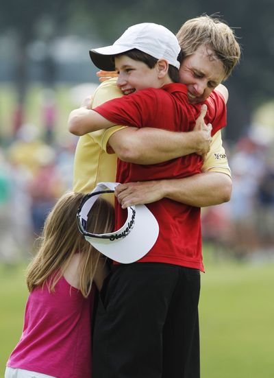 Victorious David Toms is hugged by his children Carter, 13, and Anna, 5. (Associated Press)