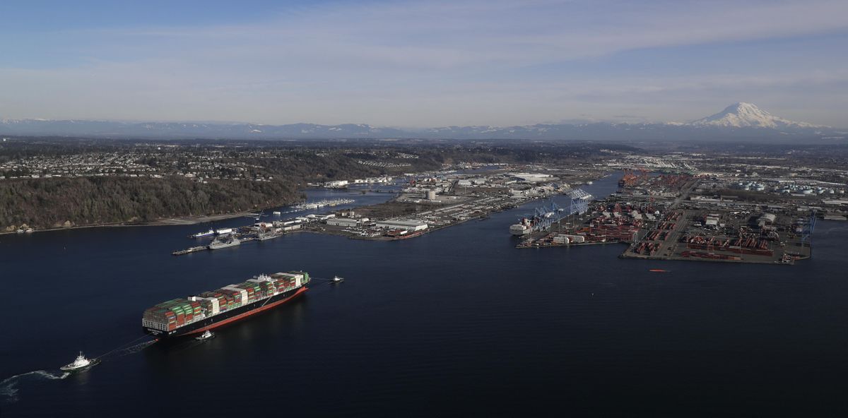 The container ship Cape Kortia heads into the Port of Tacoma  on Commencement Bay on Tuesday. (associated press)
