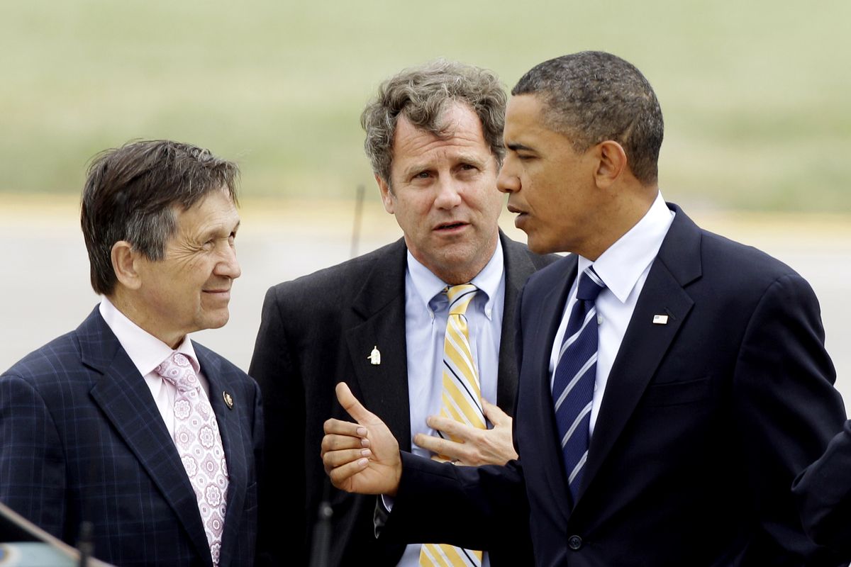President Barack Obama talks with Rep. Dennis Kucinich, D-Ohio, left, and Sen. Sherrod Brown, D-Ohio, center, upon his arrival at Cleveland Hopkins Airport on Wednesday, Sept. 8, 2010. (Mark Duncan / Associated Press)