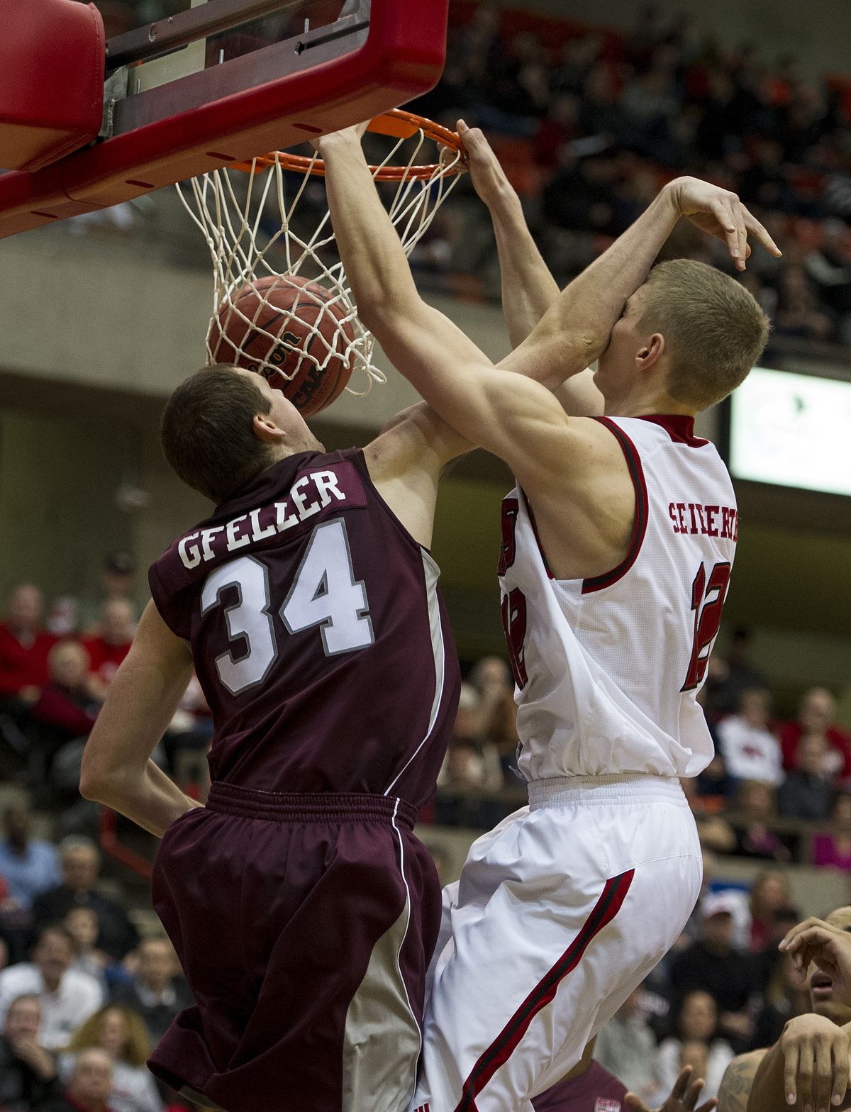 EWU’s Martin Seiferth, right, dunks the ball in the face of Montana’s Brandon Gfeller in the second half. (Colin Mulvany)