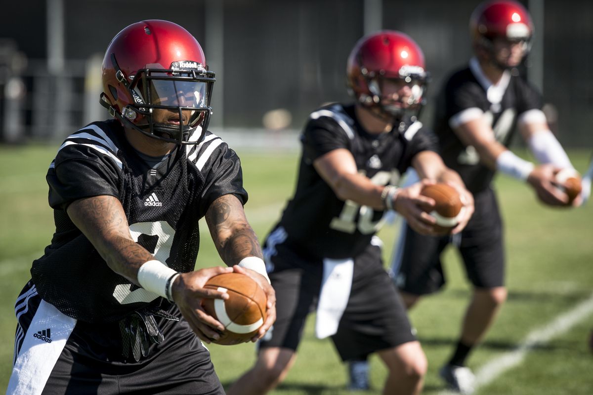 EWU quarterbacks, left to right, injured starter Vernon Adams Jr., Connor Richardson and fill-in starter Jordan West run drills. (Colin Mulvany)