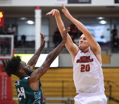 Eastern Washington guard Cody Benzel fires up a 3-pointer over Wisconsin-Green Bay guard Jevon Smith on  Nov. 16, 2018, in Cheney. (Dan Pelle / The Spokesman-Review)