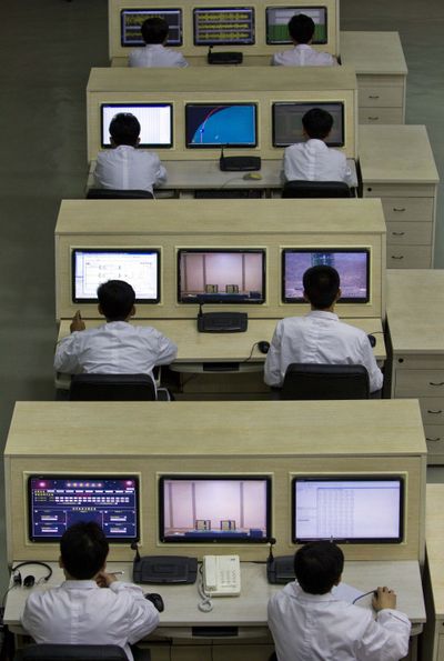 Technicians man computer terminals at North Korea’s space agency’s General Launch Command Center Wednesday. (Associated Press)