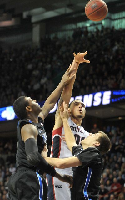 Gonzaga's Robert Sacre tries a shot while Memphis' Tarik Black, left, and Drew Barham, right, try to prevent it. The Tigers pulled past the Bulldogs, 62-58, on Saturday, Feb. 5, 2011. (Jesse Tinsley / The Spokesman-Review)