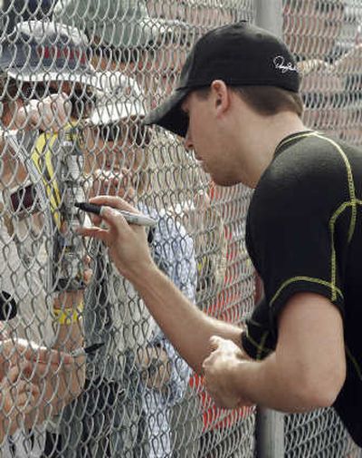 
Denny Hamlin signs autographs Saturday prior to practice for the NASCAR Daytona 500. Associated Press
 (Associated Press / The Spokesman-Review)