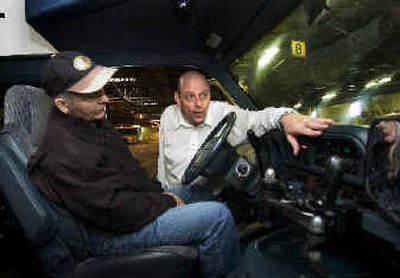 
STA training instructor Paul Hoffman shows paratransit volunteer driver Marc Hayes the features of the van he will drive for the new 