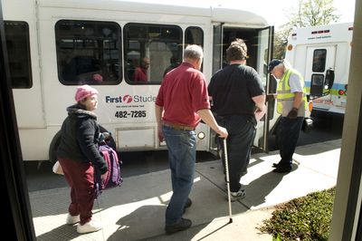 Users of the Arc Community Center, 116 W. Indiana Ave.,  board a paratransit van last week contracted by the Spokane Transit Authority. Some people with disabilities and their advocates say an STA plan to nearly triple paratransit fares would cause hardship. Fares  on regular routes would go up by less. (Colin Mulvany / The Spokesman-Review)