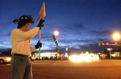 
Firefighter Jake Bieker urges passage of a safety bond  at U.S. Highway 95 and Interstate 90 on Tuesday evening. 
 (Jesse Tinsley / The Spokesman-Review)