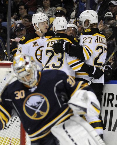 Buffalo goalie Ryan Miller, bottom, can’t watch Boston celebrate. (Associated Press)