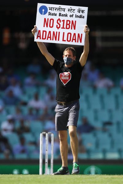 A man protests the Adani coal mine in Australia after invading the pitch during a cricket match between Australia and India on Nov. 27, 2020, in Sydney.  (Mark Kolbe)