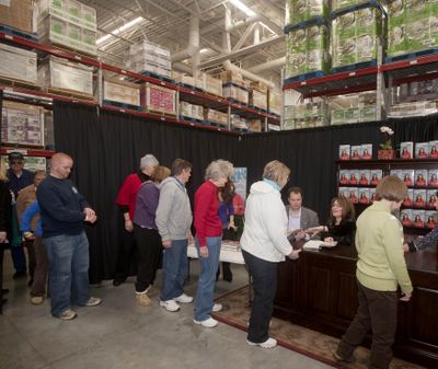 Former Alaska Gov. Sarah Palin signs a copy of 