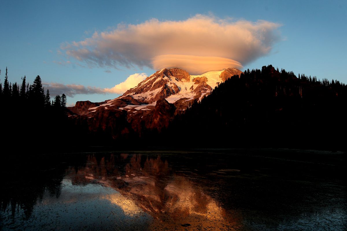 A lenticular cloud hovers over Mount Rainier at sunset in this view from Klapatche Park Camp in Mount Rainier National Park in 2012.  (Drew Perine)