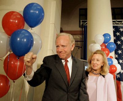 
U.S. Sen. Joseph Lieberman, D-Conn., pumps his fist as his wife, Hadassah, stands behind him at the conclusion of his election night campaign event  Tuesday.
 (Associated Press / The Spokesman-Review)
