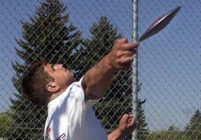 
West Valley High senior Kevin Lemieux releases a discus during an after school practice at West Valley. Lemieux is one of the leaders in the state.
 (Liz Kishimoto / The Spokesman-Review)