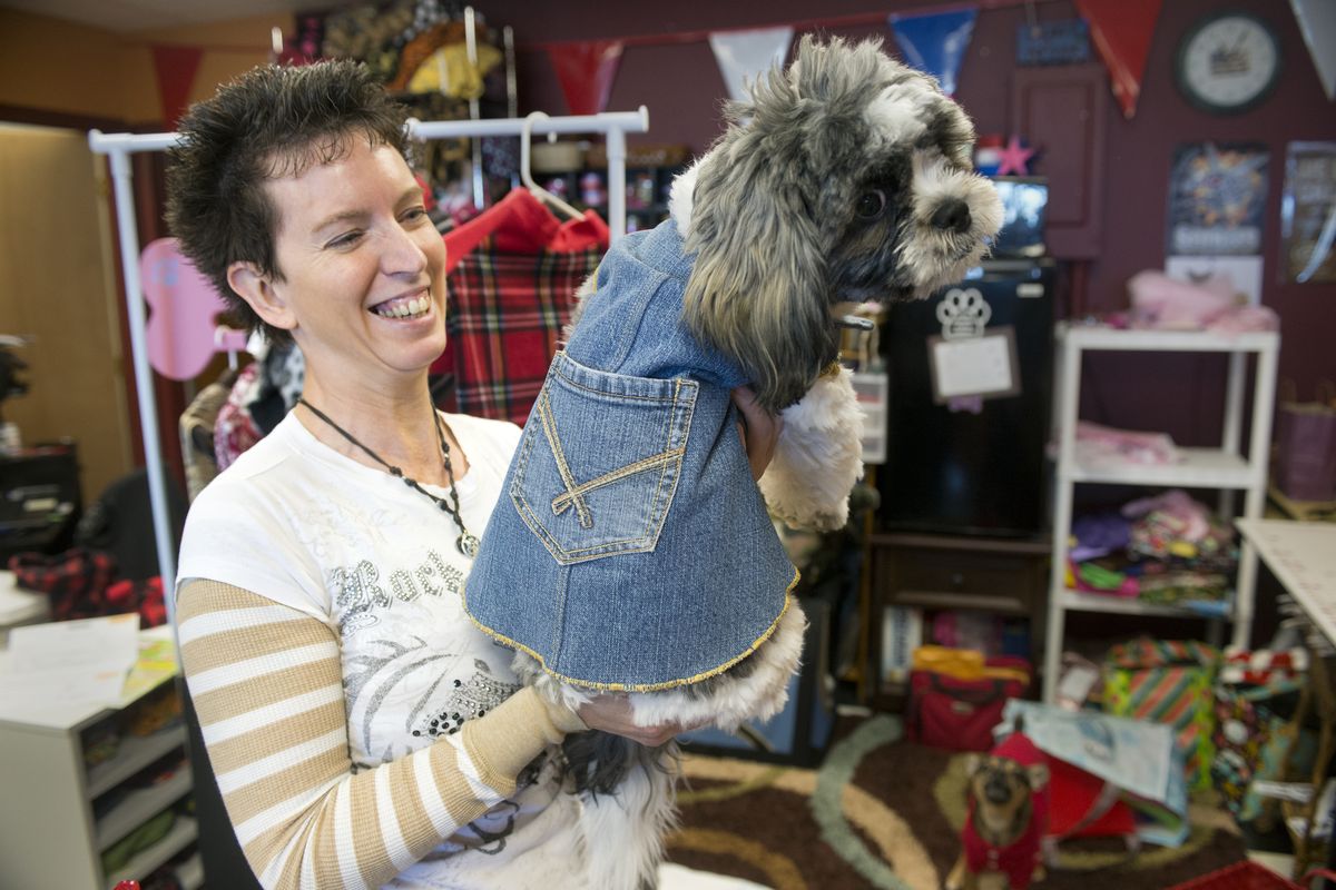 Cathleen Powell shows Bobo, wearing one of her original creations at Max’s Custom Pet Clothing on April 10. Powell sells ready-made and custom-made clothing, hats and accessories for dogs and cats. She also sells pet food and toys. (Jesse Tinsley)