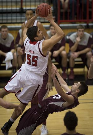 Eastern Washington forward Venky Jois (55) drives to the basket as Montana forward Michael Weisner (33) falls during the first half of a men's college basketball game, Wed., Jan. 9, 2014, on Reese Court in Cheney, Wash. (Colin Mulvany / The Spokesman-Review)