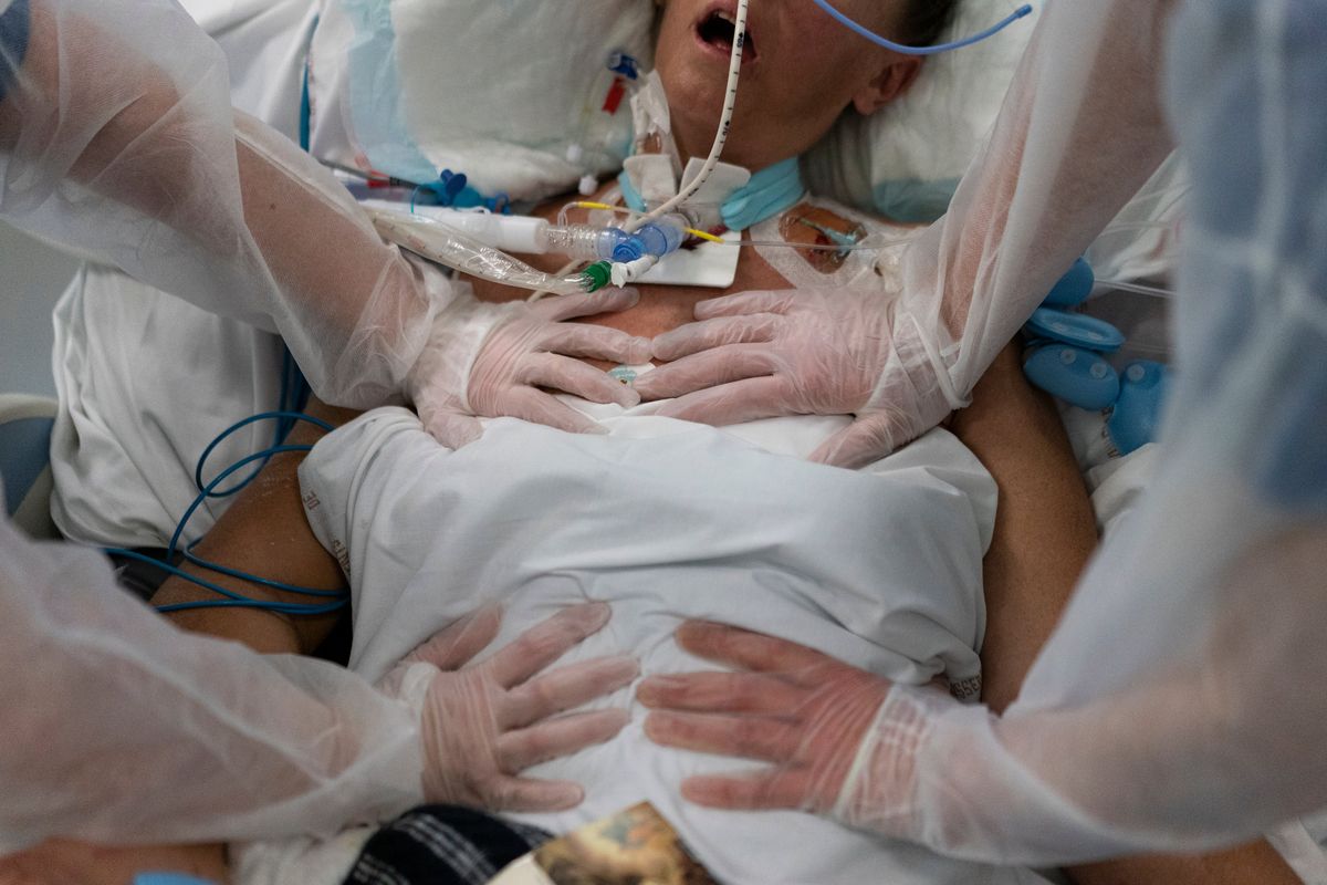 FILE - Nurses perform timed breathing exercises on a COVID-19 patient on a ventilator in the COVID-19 intensive care unit at the la Timone hospital in Marseille, southern France, Friday, Dec. 31, 2021. The official global death toll from COVID-19 is on the verge of eclipsing 6 million — underscoring that the pandemic, now in its third year, is far from over.  (Daniel Cole)