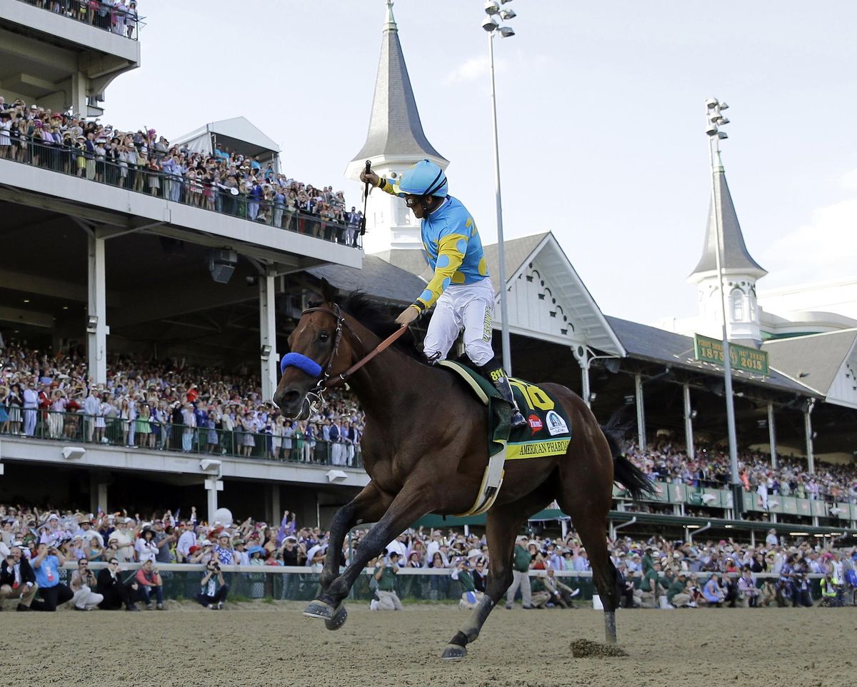 In this May 2, 2015 file photo, jockey Victor Espinoza celebrates aboard American Pharoah after winning the 141st running of the Kentucky Derby horse race at Churchill Downs in Louisville, Ky. (David J. Phillip / Associated Press)