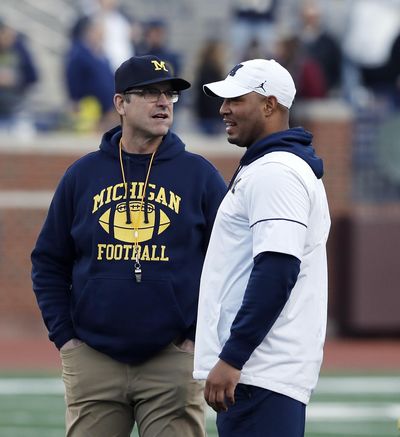 In this April 13, 2019 photo Michigan head coach Jim Harbaugh, left, and offensive coordinator Josh Gattis talk during the team’s annual spring NCAA college football game in Ann Arbor, Mich. Harbaugh seems to be set up for success at Michigan in his fifth season, leading a program that is a popular choice to win the Big Ten. (Carlos Osorio / Associated Press)