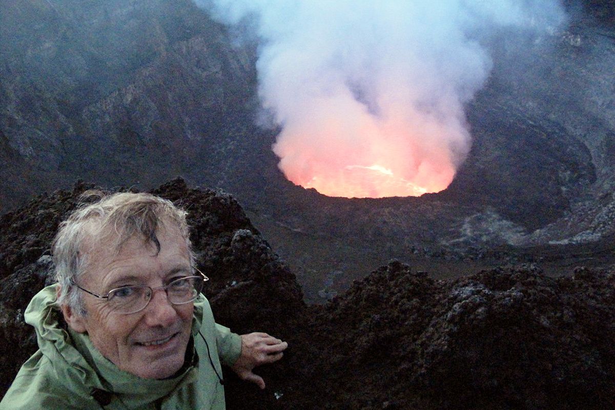Tony Wheeler, co-founder of Lonely Planet, stands at the crater rim of the Nyiragongo Volcano near Goma in the Democratic Republic of Congo in June 2011. (Associated Press)