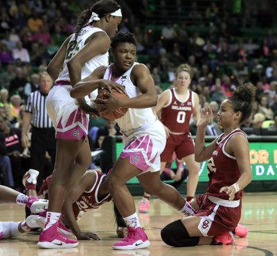 Baylor guard Moon Ursin, center, controls a defensive rebound as center Queen Egbo (25) and Oklahoma guard Ana Llanusa, right, watch during the first half of an NCAA college basketball game in Waco, Texas, Saturday, Feb. 16, 2019. Baylor won 87-53. (Tony Gutierrez / Associated Press)