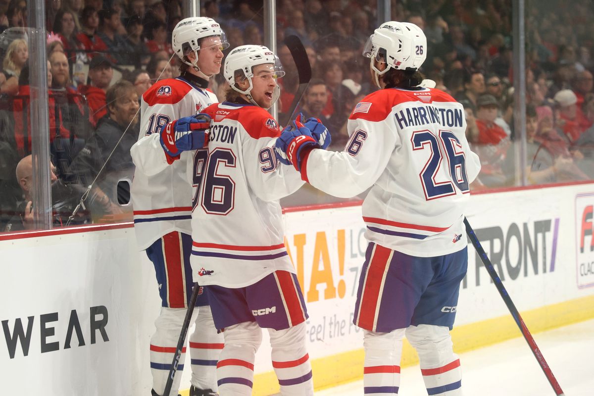 Spokane Chiefs’ Mathis Preston (96) celebrates with teammates Will McIsaac (18) and Chase Harrington (26) after scoring against Portland in Game 3 of the Western Conference Championship on April 30 at the Memorial Coliseum in Portland. All three return to the Chiefs roster for the 2025-26 season.  (Jaime Valdez)