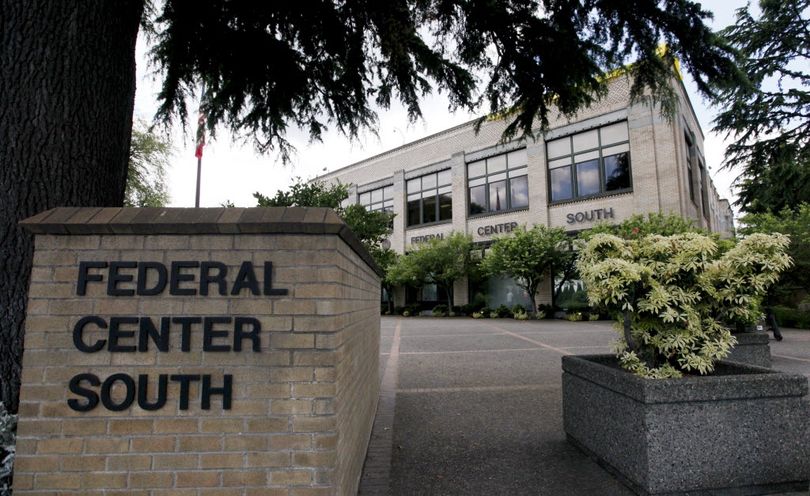 A federal building that houses the Seattle Military Processing Center is seen Thursday, June 23, 2011, in Seattle. Two men have been arrested in a plot to use machine guns and grenades in an attack on the military recruiting station there that also houses a daycare, the U.S. Justice Department said Thursday. Abu Khalid Abdul-Latif, also known as Joseph Anthony Davis, of Seattle, and  Walli  Mujahidh, also known as Frederick Domingue Jr., of Los Angeles, were arrested Wednesday night. ((AP Photo/Elaine Thompson))