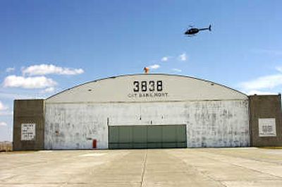 
A National Guard helicopter flies over a hangar at the Cut Bank, Mont., airport on Tuesday. Associated Press
 (Associated Press / The Spokesman-Review)