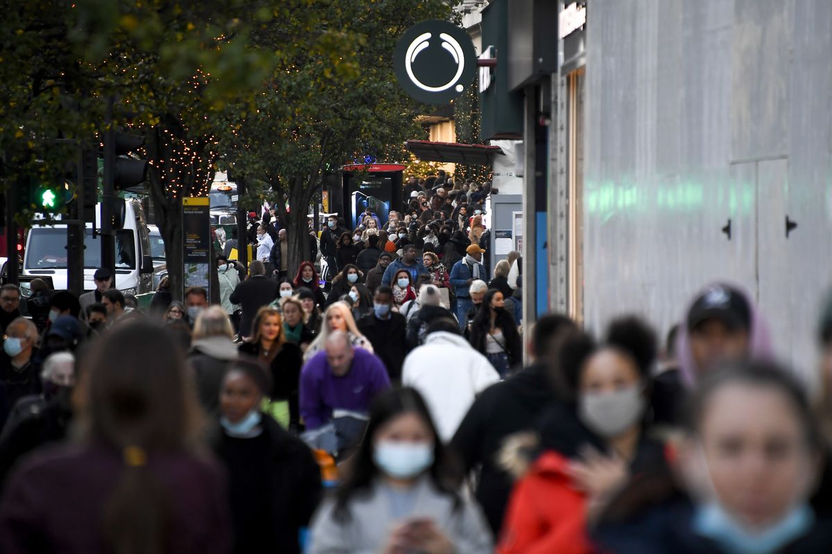 People walk along Oxford Street, London, Wednesday, Nov. 4, 2020, as Britain prepares to join large swathes of Europe in a coronavirus lockdown designed to save its health care system from being overwhelmed. Pubs, along with restaurants, hairdressers and shops selling non-essential items will have to close Thursday until at least Dec. 2.  (Alberto Pezzali)