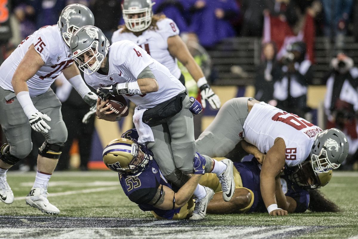 WSU QB Luke Falk is sacked in the first quarter by U of W Ryan Bowman (55) during the Apple Cup in Husky Stadium, Saturday, Nov. 25, 2017, in Seattle, Wash. (Dan Pelle / The Spokesman-Review)