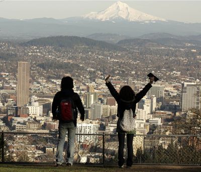 In this file photo from  February 2008, a young couple enjoys the view of Mount Hood over downtown on a spring-like day in Portland. (Associated Press / The Spokesman-Review)