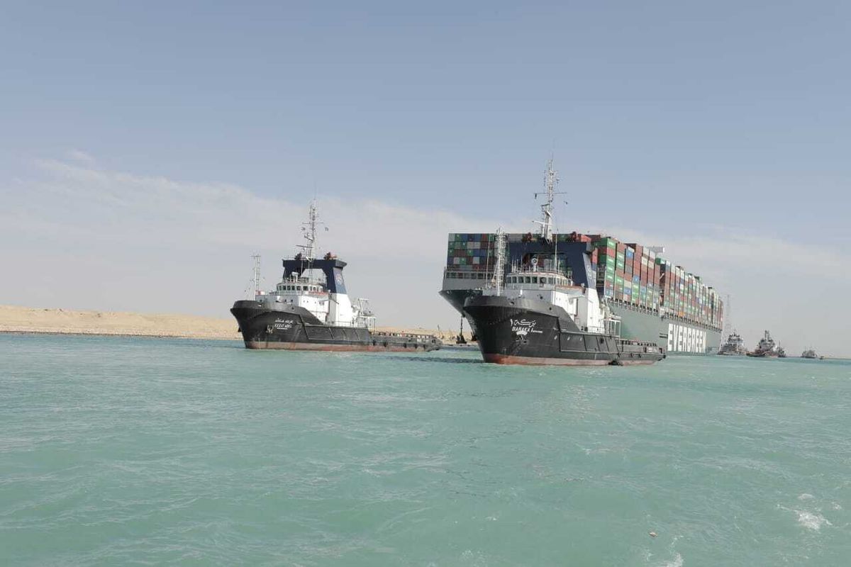 FILE - In this Monday, March 29, 2021, file photo released by Suez Canal Authority, the Ever Given, a Panama-flagged cargo ship is accompanied by Suez Canal tugboats as it moves in the Suez Canal, Egypt. The Suez Canal Authority on Sunday, July 4, 2021, said it has reached an agreement to settle a financial dispute with the owners of the hulking container ship that blocked the crucial waterway for nearly a week earlier this year. The authority did not reveal details on the settlement deal with the Shoei Kisen Kaisha Ltd., the Japanese owner of the Ever Given.  (HOGP)