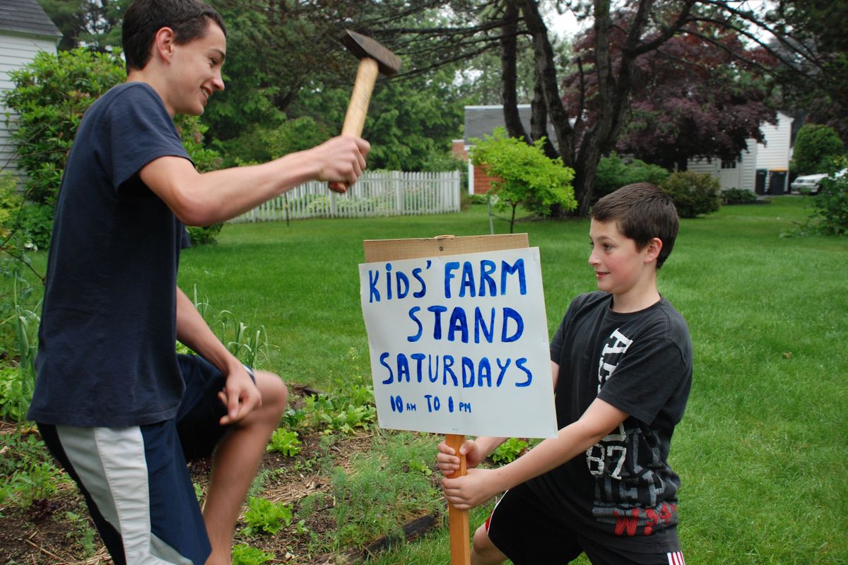 Two of Doiron’s sons, Maxim, left, and Sebastian, ran a Saturday farm stand from the family driveway in Scarborough, Maine, in June 2012. MUST CREDIT: Roger Doiron  (Photo by Roger Doiron/Photo by Roger Doiron)