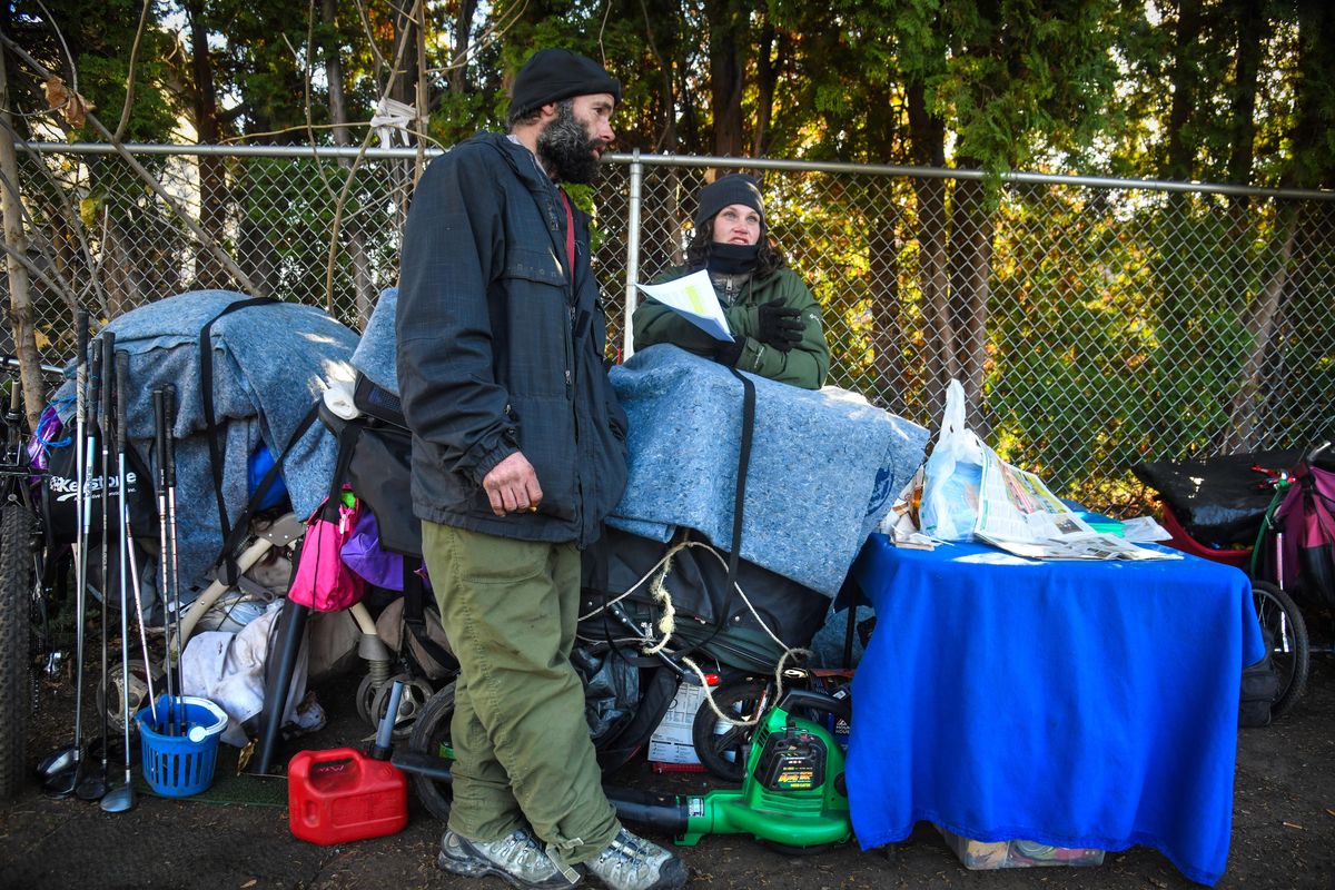 Nic Mischke and Angela Dallman, along with their possessions, spend the afternoon of Friday, Nov. 1, 2019, at Balfour Park in Spokane Valley, Wash. They were planning to move the belonging to a storage facility before the evening. Spokane Valley City Council is about to ban camping in Balfour Park all the time, and other parks most of the time. They
