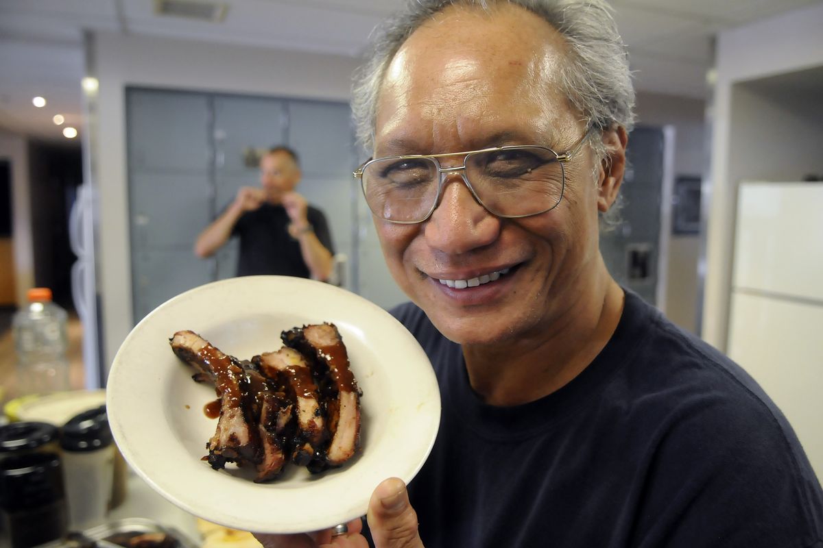 Tony Yuen displays his barbecue sauce on ribs he prepared for fellow firefighters at Station 13 in Spokane on Wednesday. Yuen won a national contest for his Hawaiian-inspired sauce, along with a check for $10,000 for a charity of his choosing. (Dan Pelle)