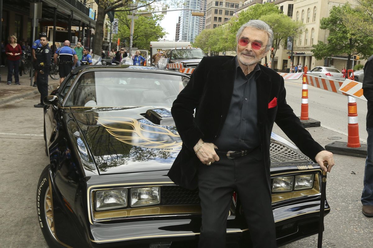 FILE - In this March 12, 2016 file photo, Burt Reynolds sits on a 1977 Pontiac Trans-Am at the world premiere of "The Bandit" at the Paramount Theatre during the South by Southwest Film Festival in Austin, Texas. Hundreds of fans in Trans Ams made it to Atlanta to celebrate the 40th anniversary of "Smokey and the Bandit." About 350 cars retraced actor Burt Reynolds