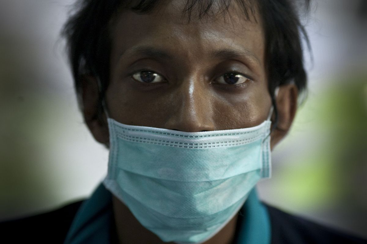 Tuberculosis and HIV patient Vancherleum Maharathanaing, 33, looks out from the isolation ward at Wat Prabat Nampu, in Lopburi, Thailand, last October.