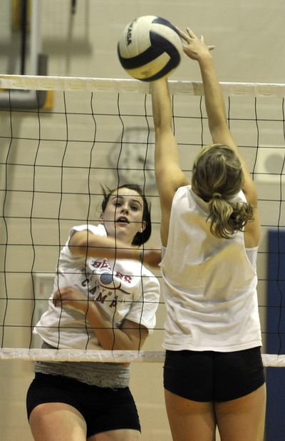 Central Valley High School volleyball player, Mikayla Ness, left, sneaks a kill past defender, Andrea Heartburg, during practice at the school, Thursday.  (Dan Pelle)