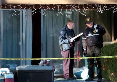 
Whitman County Coroner Pete Martin, right, talks with Mike Shaw, of the Washington State University Police Department, on Sunday outside the condominium where Pullman police, state investigators and Whitman County coroners are investigating three shooting deaths. 
 (Joe Barrentine / The Spokesman-Review)