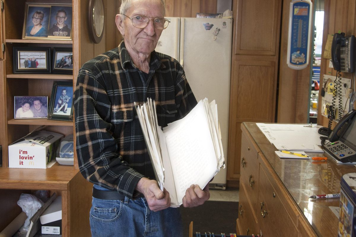 Roger Kimmet has a 2-inch-thick folder full of humorous messages he can put on the sign of his Garland Auto business. He says his daughter Kelley Arnold chooses one every month. (Dan Pelle / The Spokesman-Review)