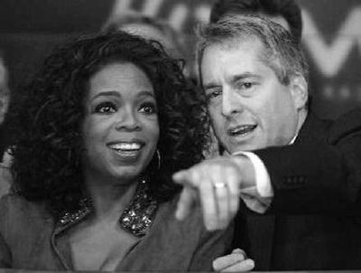 
Oprah Winfrey and Hugh Panero, CEO of XM Satellite Radio, preside over the Nasdaq opening bell on Sept. 25. Federal regulators warn that combining rivals Sirius Satellite and XM Satellite Radio will be a tough process.
 (Associated Press / The Spokesman-Review)