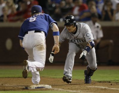 Rangers first baseman Hank Blalock prepares to tag Kenji Johjima after Johjima overran the bag. (Associated Press / The Spokesman-Review)