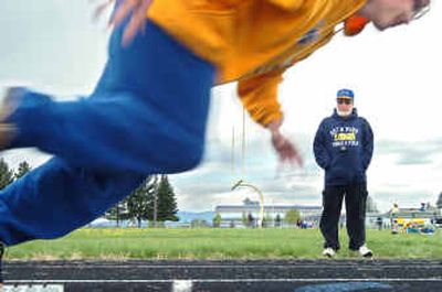 Volunteer Deer Park coach Glenn Wolf watches the form of sprinter Marty Hodneland. Wolf still holds two school sprint records set in 1959.
(Joe Barrentine / The Spokesman-Review)