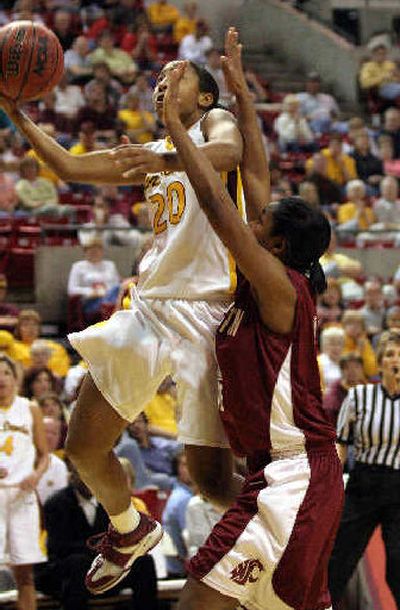 
Arizona State's Briann January, left, shoots against WSU's Crystal Blue. 
 (Associated Press / The Spokesman-Review)