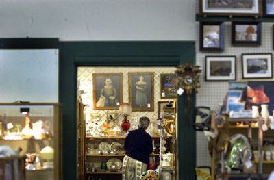 
A customer pokes through all the nooks and crannies of an antique shop just north of the Monroe Street Bridge.
 (File/ / The Spokesman-Review)