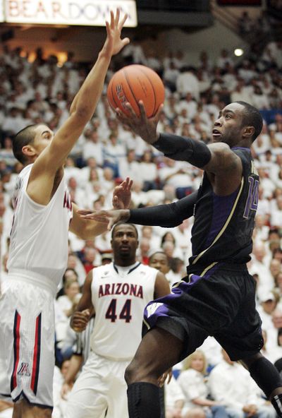 Washington freshman Tony Wroten drives to the basket around Arizona’s Nick Johnson during the first half. (Associated Press)